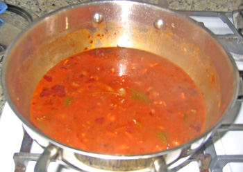 Kidney beans cooking in pot on stove, blended with all the spices and ingredients